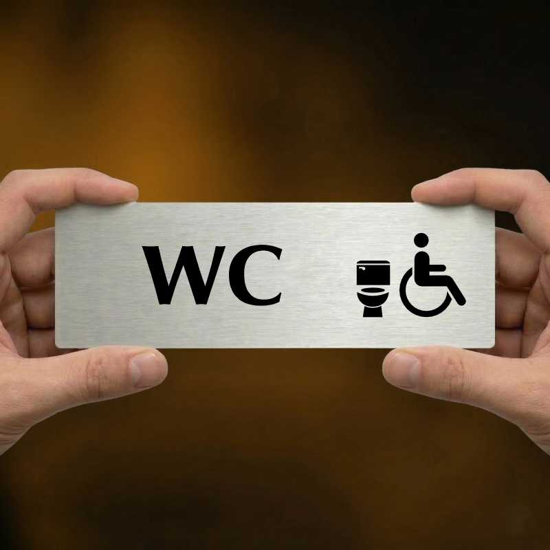 WC invalida, 240x79mm, stříbrná popiska s ozdobou uprostřed