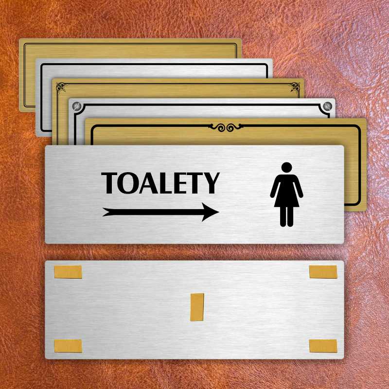 Toalety vpravo ženy, 240x79mm, zlatá popiska s okrasným rámečkem  