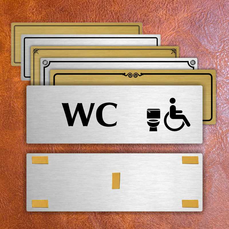 WC invalida, 240x79mm, stříbrná popiska s ozdobou uprostřed