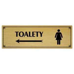 Toalety vlevo ženy, 240x79mm, zlatá popiska s okrasným rámečkem  